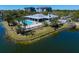 Beautiful community pool with ample seating surrounded by lush tropical landscaping and lake views at 14810 Rue De Bayonne # 2D, Clearwater, FL 33762