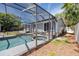 Backyard featuring an enclosed pool and spa surrounded by a well-manicured lawn at 157 7Th Sw Ave, Largo, FL 33770