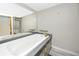 Bathroom showcasing a soaking tub with tile surround and a large mirror at 157 7Th Sw Ave, Largo, FL 33770