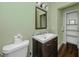 Bathroom featuring hardwood floors, a modern vanity, and a separate toilet room at 157 7Th Sw Ave, Largo, FL 33770