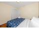A cozy bedroom featuring a closet and a bed with a blue patterned comforter and white pillows at 157 7Th Sw Ave, Largo, FL 33770