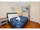 Bright bedroom featuring hardwood floors, a comfortable bed, and a large window at 157 7Th Sw Ave, Largo, FL 33770