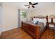 Cozy bedroom featuring hardwood floors, a comfortable bed, and a large window at 157 7Th Sw Ave, Largo, FL 33770