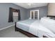 Cozy bedroom featuring a comfortable bed, a window, and a pair of french doors at 157 7Th Sw Ave, Largo, FL 33770