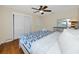 A cozy bedroom featuring a closet, dresser, and a bed with a blue patterned comforter and white pillows at 157 7Th Sw Ave, Largo, FL 33770