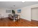Bright dining room with hardwood floors, a large dining table, and natural light from the window at 157 7Th Sw Ave, Largo, FL 33770