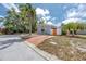 Cozy single-story home with a spacious driveway, orange door, and desert landscaping for easy maintenance at 157 7Th Sw Ave, Largo, FL 33770