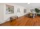 Elegant foyer with hardwood floors, a white door, and a view into the dining room and kitchen at 157 7Th Sw Ave, Largo, FL 33770