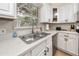 Well-lit kitchen with white cabinets, granite countertops, and stainless steel appliances at 157 7Th Sw Ave, Largo, FL 33770