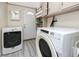 Laundry room with washer, dryer, cabinets, and shelves for storage at 157 7Th Sw Ave, Largo, FL 33770