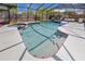 Enclosed pool with a red tile border and plenty of lounge seating at 157 7Th Sw Ave, Largo, FL 33770