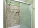 Shower featuring a tile surround and a glass sliding door at 157 7Th Sw Ave, Largo, FL 33770