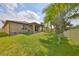 Well-maintained backyard featuring lush lawn and mature landscaping, perfect for outdoor enjoyment at 1612 Cabbage Key Dr, Ruskin, FL 33570