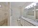 Well-lit bathroom with granite countertops, double sinks, and a tiled walk-in shower at 1612 Cabbage Key Dr, Ruskin, FL 33570