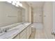 Bathroom featuring a double vanity with granite countertops, and a shower-tub combo at 1612 Cabbage Key Dr, Ruskin, FL 33570