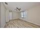 Bright bedroom featuring a ceiling fan, wood floors, and a window with sheer curtains at 1612 Cabbage Key Dr, Ruskin, FL 33570