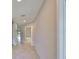 Neutral hallway showcases tile flooring, white trim, and easy access to the bathroom, kitchen, and living spaces at 1612 Cabbage Key Dr, Ruskin, FL 33570