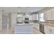 Modern kitchen featuring white cabinets, stainless steel appliances, granite countertops, and tile backsplash at 1612 Cabbage Key Dr, Ruskin, FL 33570