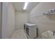 Practical laundry room features a washer and dryer, sink, and wire shelving for convenient storage at 1612 Cabbage Key Dr, Ruskin, FL 33570