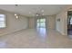 Spacious, light-filled living room with tile flooring, sliding glass doors, recessed lighting, and modern ceiling fan at 1612 Cabbage Key Dr, Ruskin, FL 33570