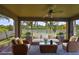 Covered lanai featuring comfortable seating, providing a serene outdoor living space with a ceiling fan and scenic views at 1612 Cabbage Key Dr, Ruskin, FL 33570