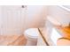 Compact bathroom featuring a toilet and vanity with granite countertop and white tiled walls at 1741 Fairfield St, Holiday, FL 34691