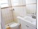 Bright bathroom featuring neutral tile, white fixtures, and a shower at 1741 Fairfield St, Holiday, FL 34691