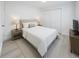 Bright bedroom features a plush bed, neutral decor, and carpeted flooring at 1741 Fairfield St, Holiday, FL 34691