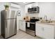 Modern kitchen with stainless steel appliances and bright, white cabinetry at 1741 Fairfield St, Holiday, FL 34691