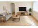 Cozy living room features a comfortable sofa, modern entertainment center, and natural light from a large window at 1741 Fairfield St, Holiday, FL 34691