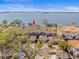 Stunning aerial view of bayfront townhomes with tile roofs, garages and water views at 2087 Edgewater Dr # C, Clearwater, FL 33755