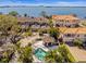 Beautiful aerial view of residences featuring a shared pool, spa and bay views at 2087 Edgewater Dr # C, Clearwater, FL 33755