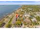 Aerial view of the community, offering waterfront views, mature trees, and nearby shops at 2087 Edgewater Dr # C, Clearwater, FL 33755