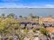 Panoramic aerial view showcasing waterfront property with bay views and mature trees at 2087 Edgewater Dr # C, Clearwater, FL 33755