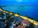 Aerial view of bayfront townhomes with lush landscaping, stunning water and city views at dusk at 2087 Edgewater Dr # C, Clearwater, FL 33755