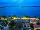 Aerial dusk view showcases a bay-front community with city views across the bay at 2087 Edgewater Dr # C, Clearwater, FL 33755