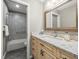 A full bathroom with a shower and tub combo, marble countertops, and a white vanity at 2087 Edgewater Dr # C, Clearwater, FL 33755