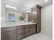 A full bathroom features dual sinks, white quartz countertops, and a decorative tile backsplash at 2087 Edgewater Dr # C, Clearwater, FL 33755