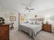 This bedroom features neutral walls, a ceiling fan, carpet, and a window with natural light at 2087 Edgewater Dr # C, Clearwater, FL 33755