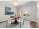 Dining area with modern chandelier and view of waterfront scenery from nearby windows at 2087 Edgewater Dr # C, Clearwater, FL 33755