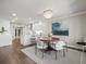 Open-concept dining room featuring a chandelier and view into a modern kitchen at 2087 Edgewater Dr # C, Clearwater, FL 33755