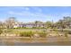 Exterior view of the condo with lush landscaping in front and beautiful bay views across the street at 2087 Edgewater Dr # C, Clearwater, FL 33755