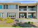 Condo exterior with balconies, bay window, seating areas and lush landscaping at 2087 Edgewater Dr # C, Clearwater, FL 33755