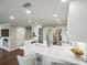 Open kitchen with white cabinets, quartz countertops, and stainless steel appliances at 2087 Edgewater Dr # C, Clearwater, FL 33755