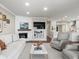 Living room with white brick fireplace, a large TV, built in shelves and cozy seating at 2087 Edgewater Dr # C, Clearwater, FL 33755