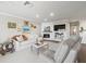 Bright living room featuring a white brick fireplace, built-in shelving, and elegant decor at 2087 Edgewater Dr # C, Clearwater, FL 33755