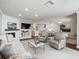 Open concept living room with white brick fireplace, seamlessly flowing into the kitchen and dining area at 2087 Edgewater Dr # C, Clearwater, FL 33755