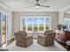 Cozy sitting area featuring a large bay window with waterfront views, and lots of natural light at 2087 Edgewater Dr # C, Clearwater, FL 33755