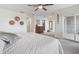 This main bedroom features a ceiling fan, neutral walls and carpet, plus a sliding glass door at 2087 Edgewater Dr # C, Clearwater, FL 33755