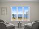 Comfortable sitting area boasts amazing waterfront views through a large window at 2087 Edgewater Dr # C, Clearwater, FL 33755